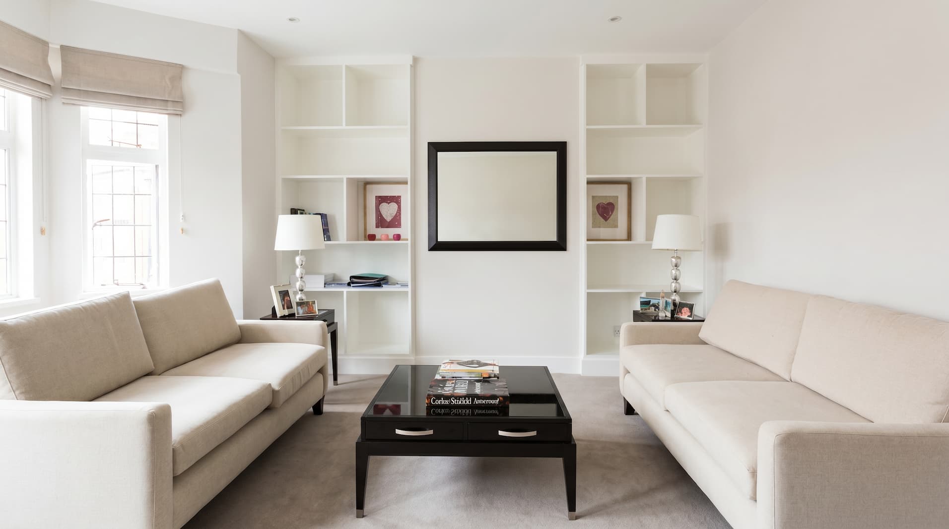 Refurbished reception room with cream sofas, bespoke alcove shelving and natural light