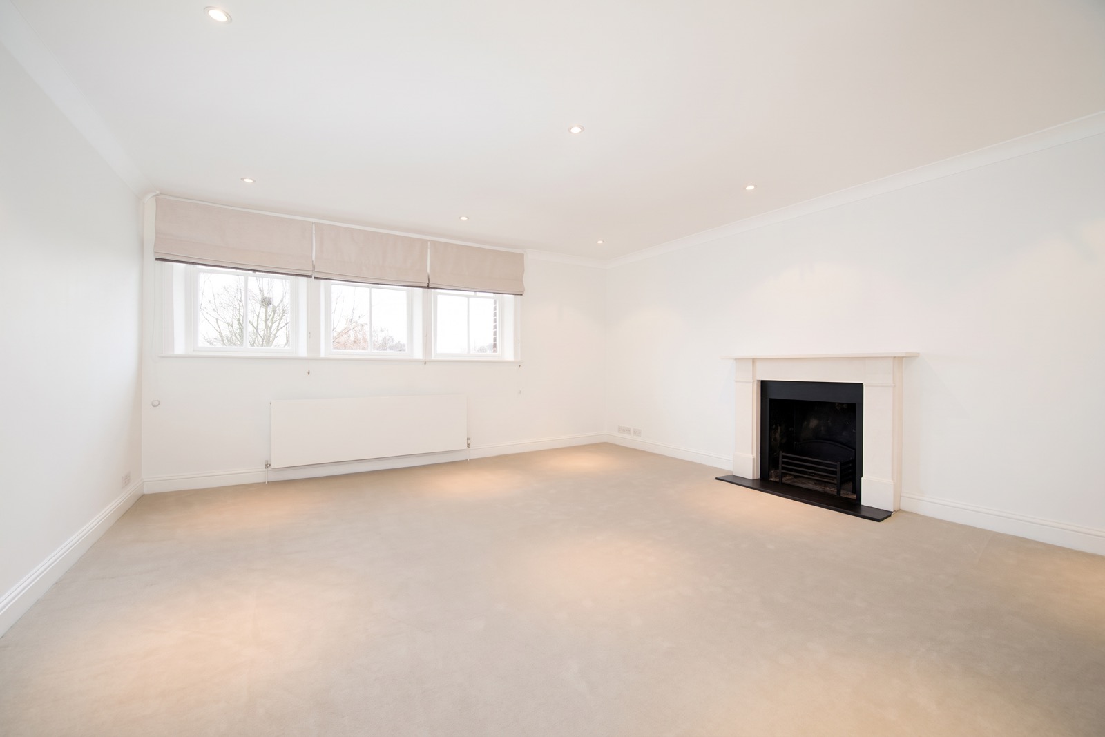 Reception room reinstated after fire damage, with fireplace and cornicing